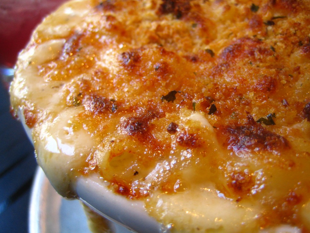 Baked mac n' cheese in a white dish.